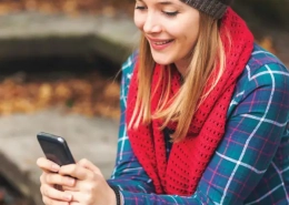 Image of a young woman interacting on social media with her mobile phone