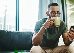 Image of a man having coffee while browsing social media