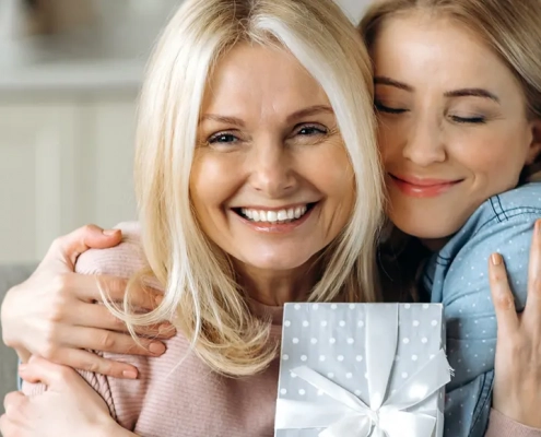 Adult daughter giving mother a gift