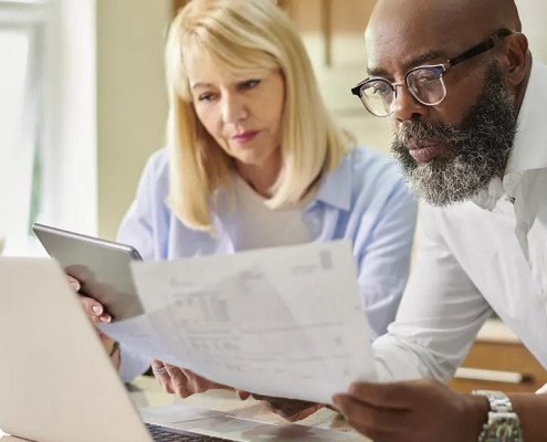 Image of an older couple looking at their finances and feeling vulnerable
